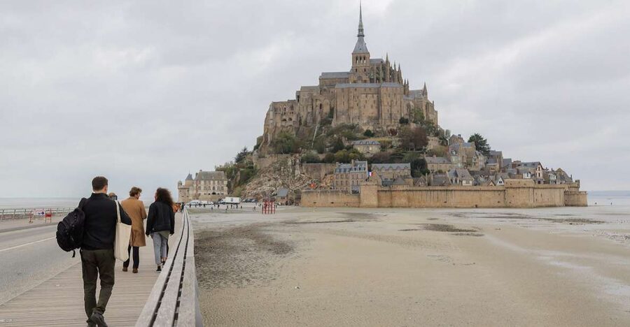 From Paris: Mont Saint-Michel Tour with Hotel Pickup Service - Entering the 11th-century abbey