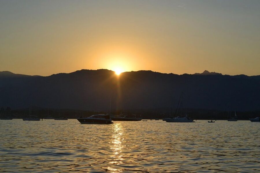 From Santa Giulia SUNSET Cruise & Apéritif - Music, mountains, and the last light