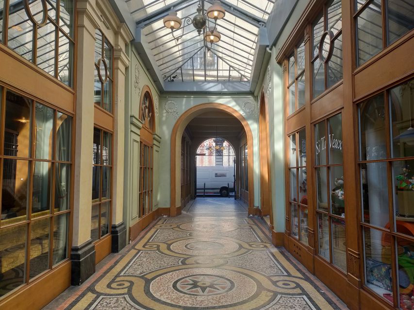 Paris: Covered Passages Walking Tour - Passage Jouffroy, glass, iron, and a wax museum